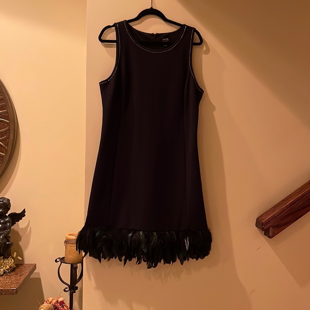 Black cocktail dress with feathers in bottom